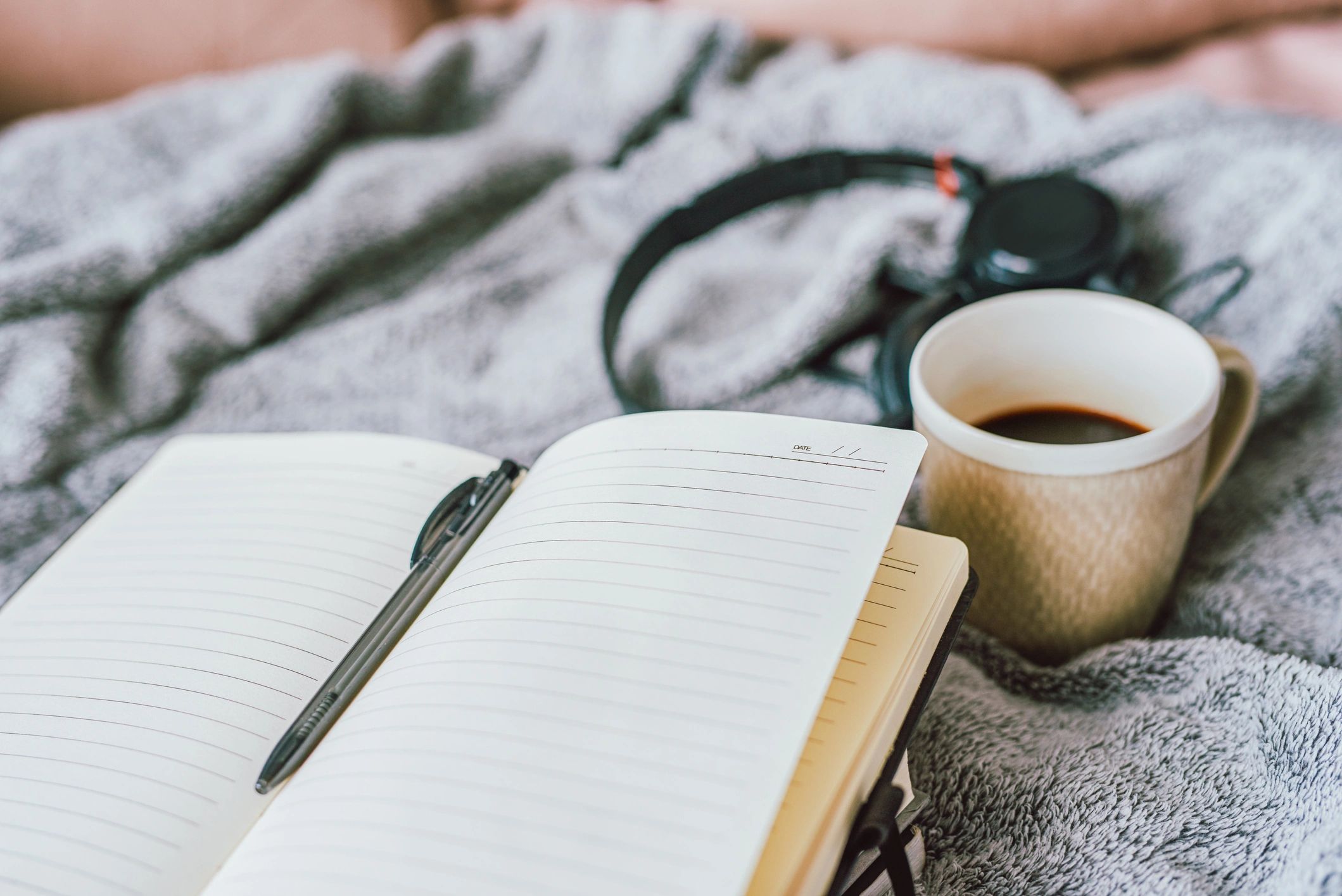 Open notebook and coffee, suggesting study and preparation